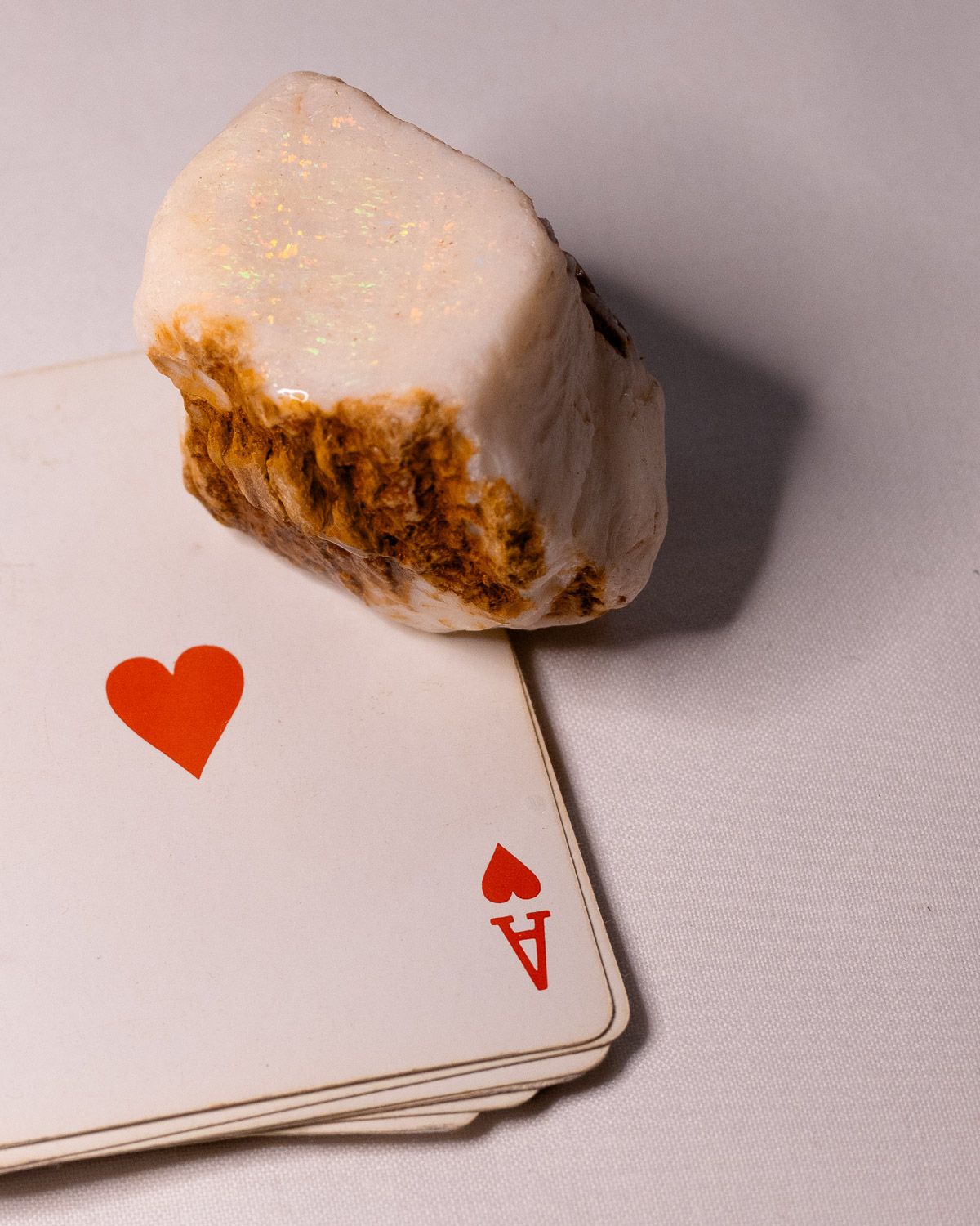 Opal No. 001 resting on an ace of hearts