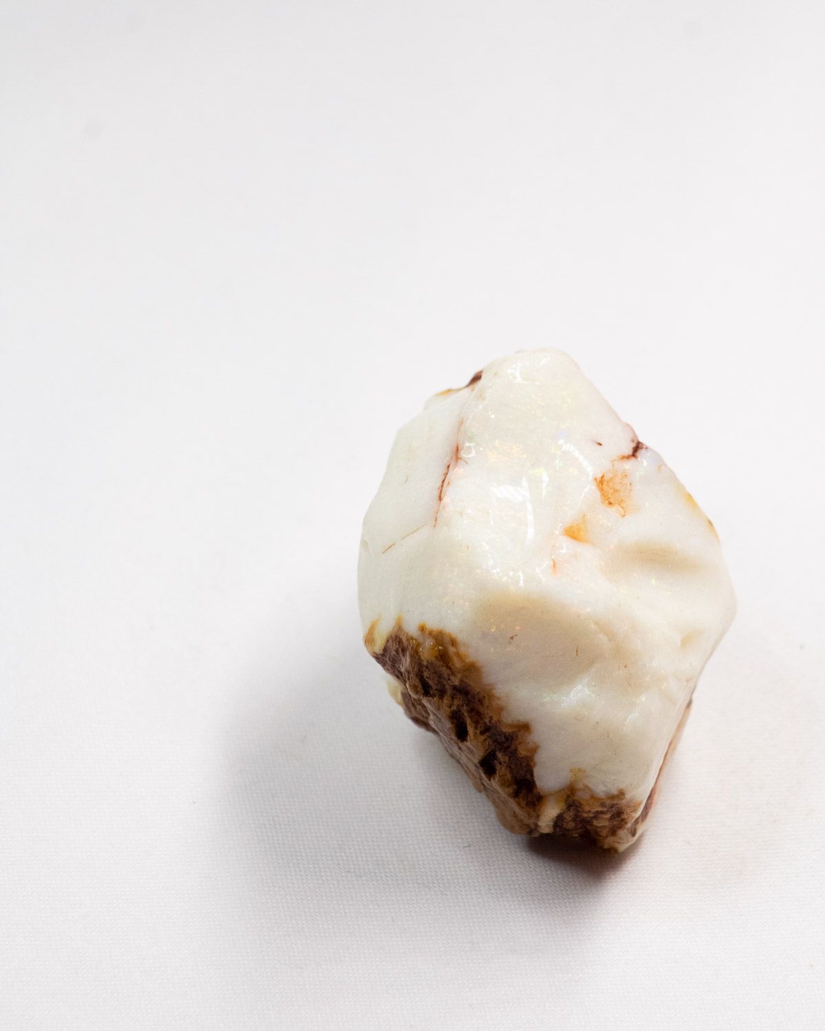 Opal No. 002, top face showing colour, ironstone at the base