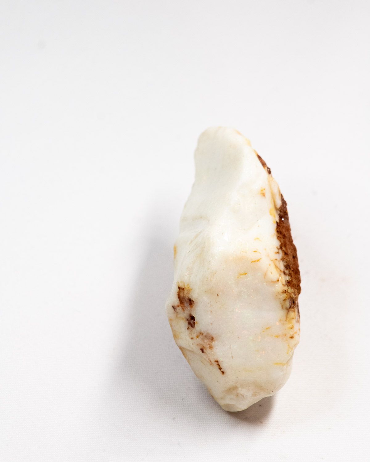 Opal No. 006, long face showing colour with an ironstone edge
