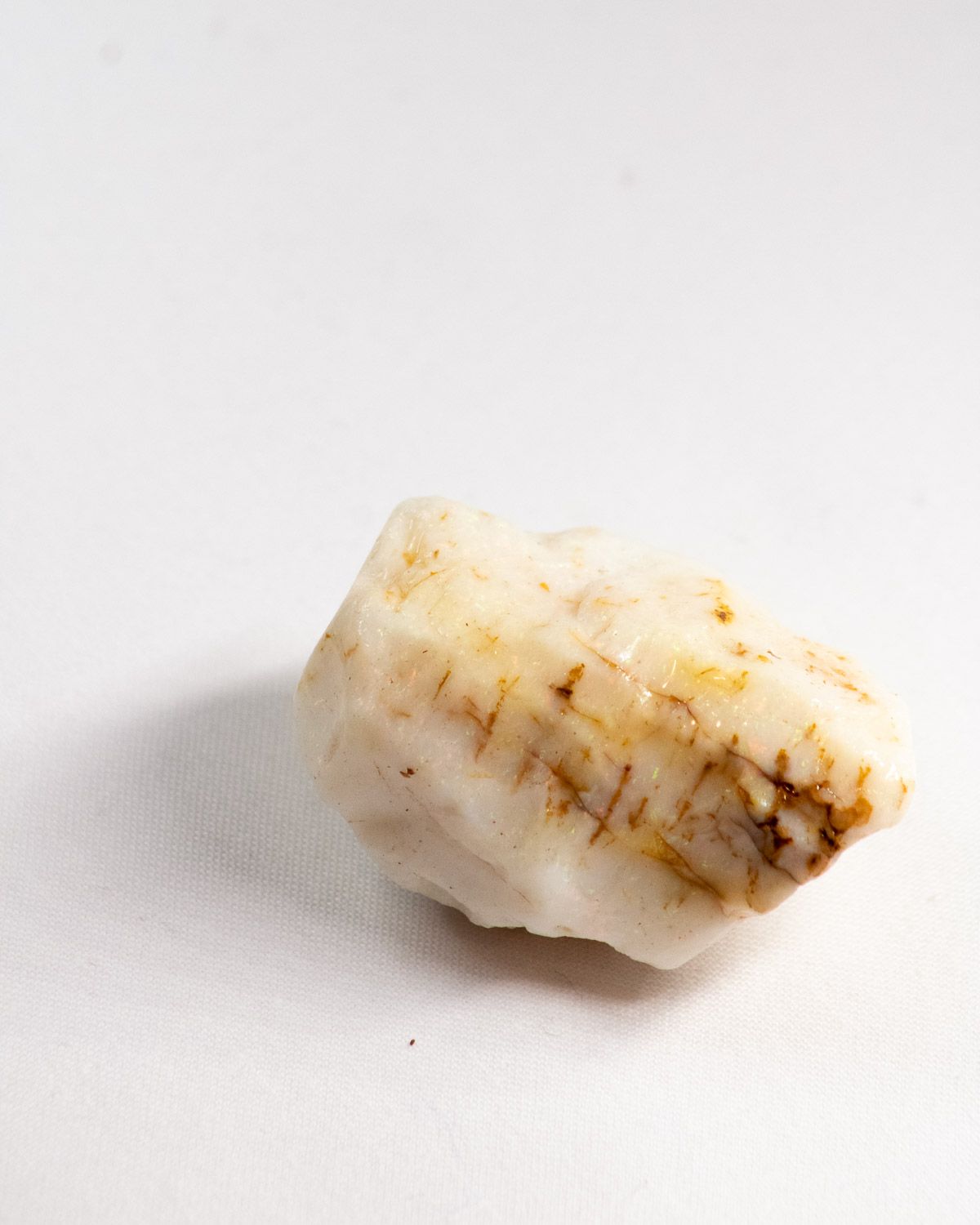Opal No. 010, face showing pin fire with fine ironstone veins
