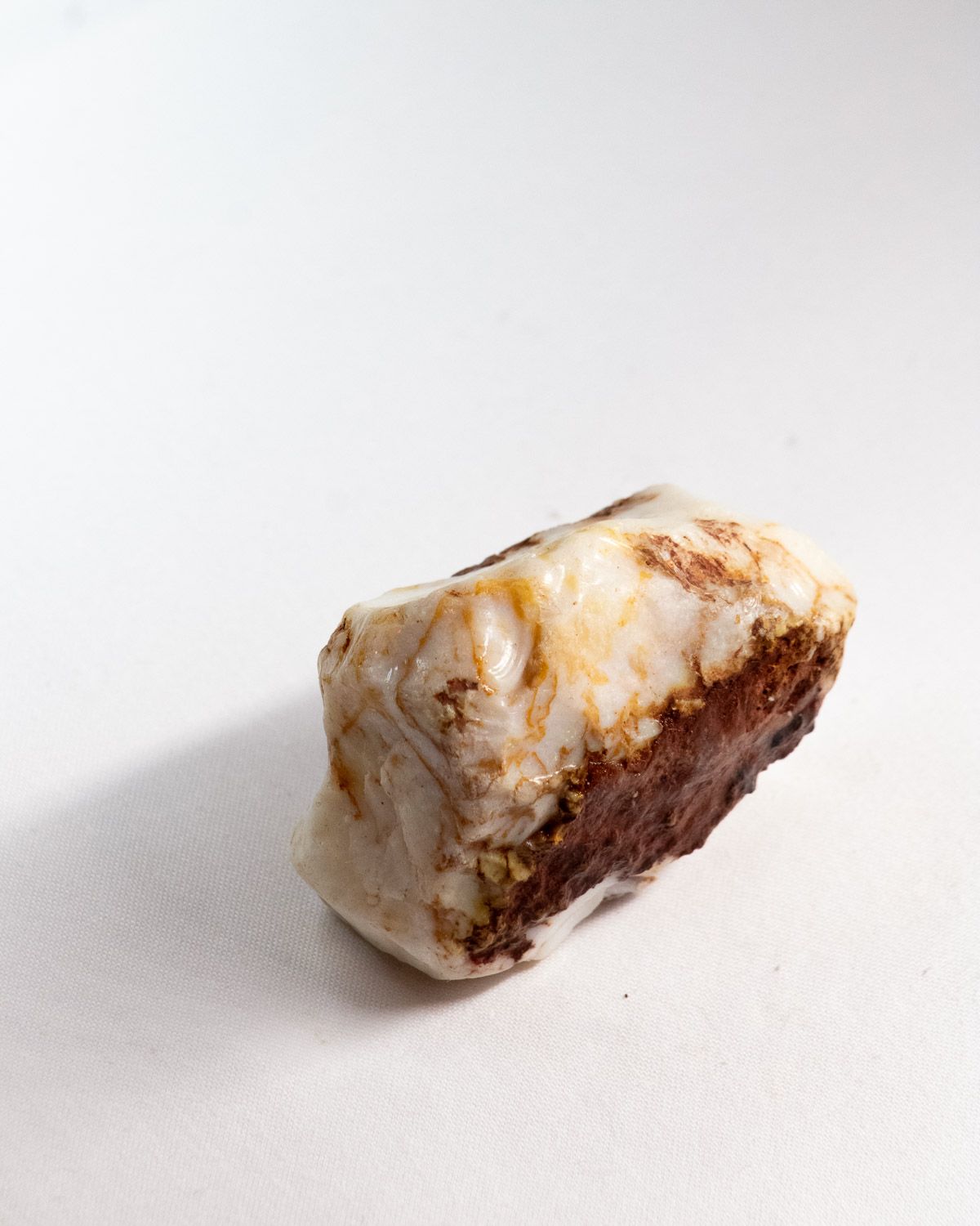 Opal No. 011, white face with ochre veins and a red ironstone base