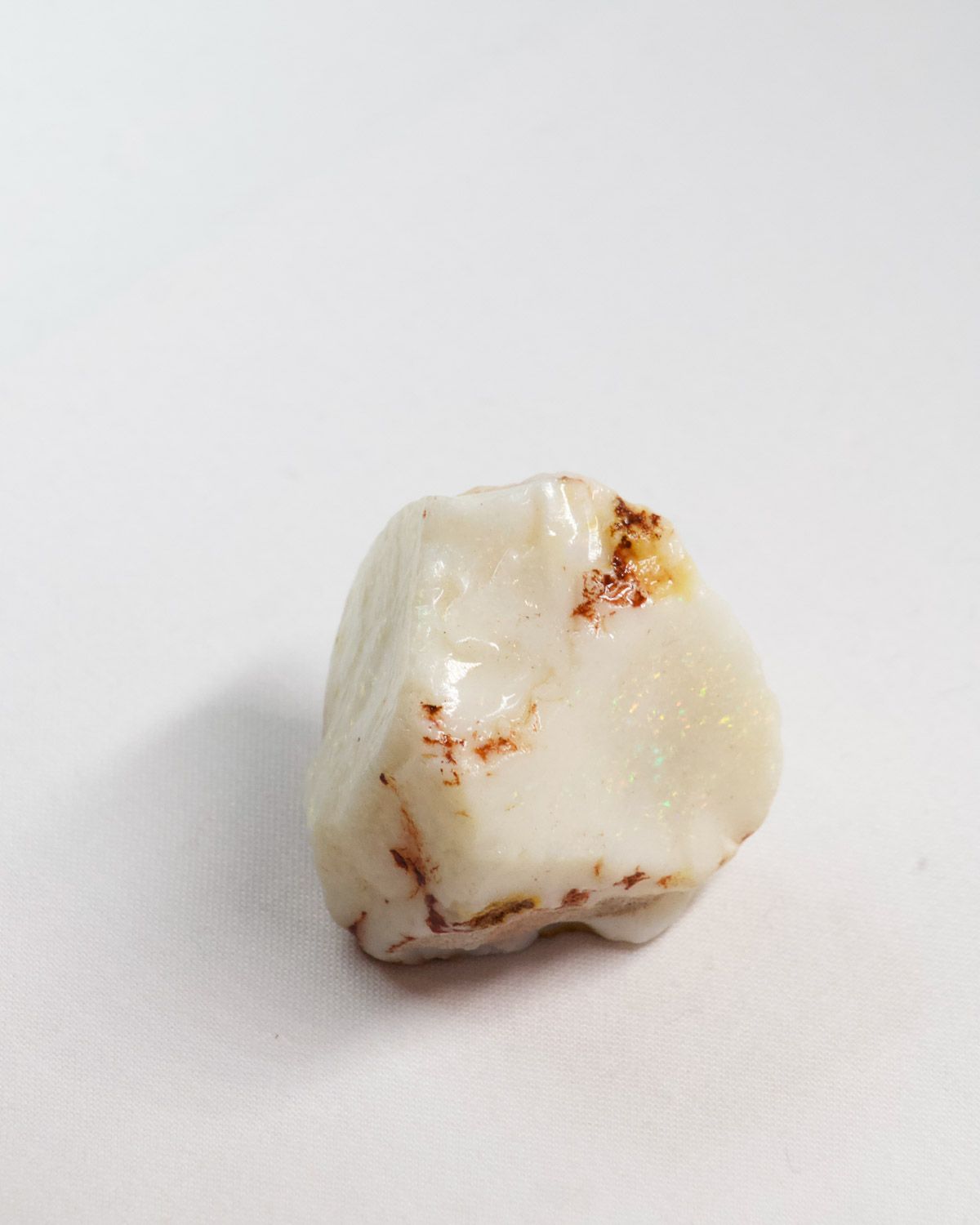 Opal No. 015, white face showing pin fire with flecks of red ironstone