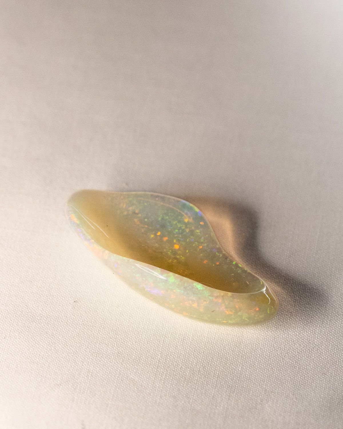 Opal No. 016, side view of the curved form with green and orange fire