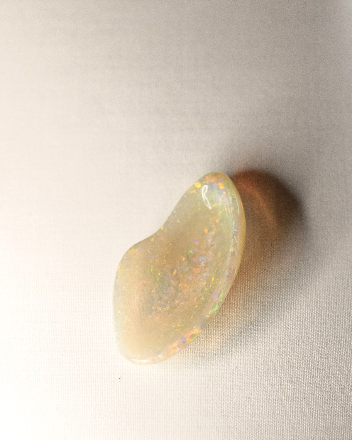 Opal No. 016, smooth honey-toned face with flashes of orange, green and violet