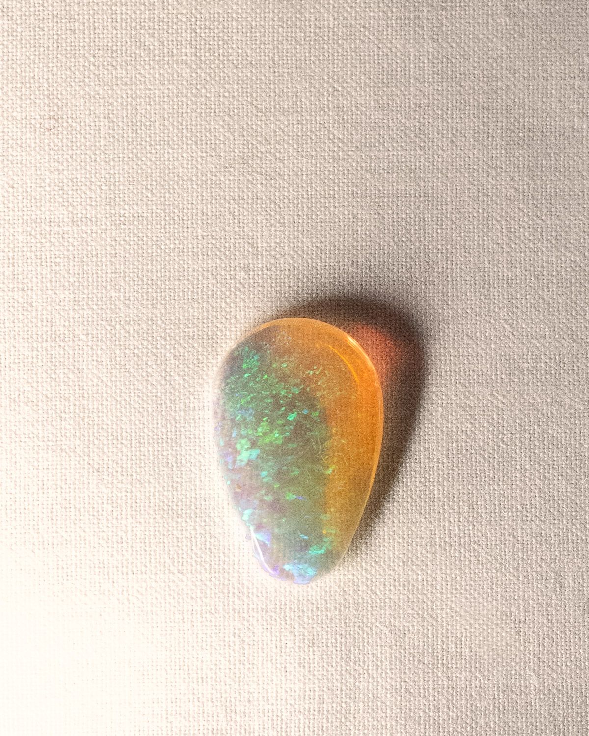 Opal No. 018, teardrop with green and blue fire beside a band of amber