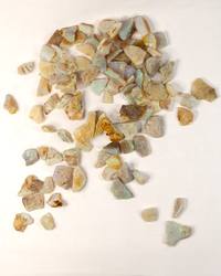 Opal No. 020, a large lot of small raw opal pieces scattered on linen